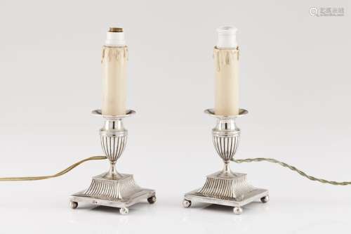 A pair of low candlesticks wired for electricity