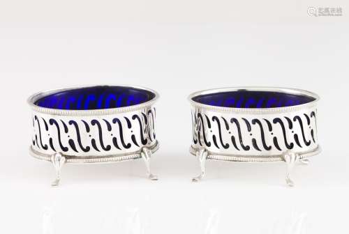 A pair of salt cellars with spoons