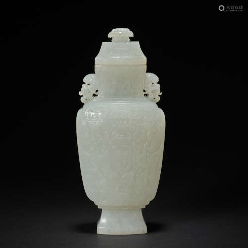 A white jade 'phoenix design, double fish-shaped handles' va...