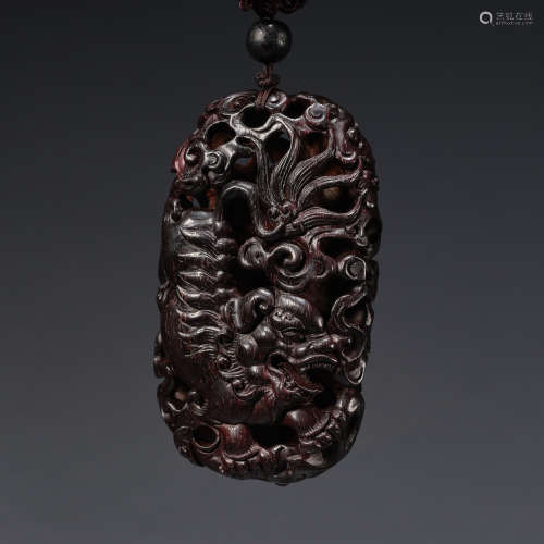 A wood 'dragon' pendant,Qing dynasty
