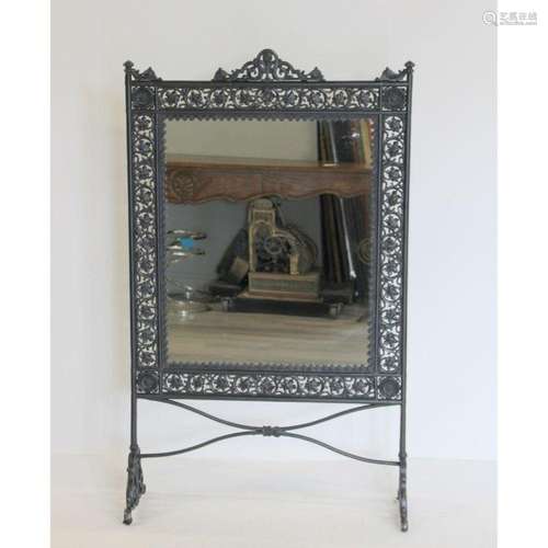 A Victorian Patinated Iron Mirrored Screen.