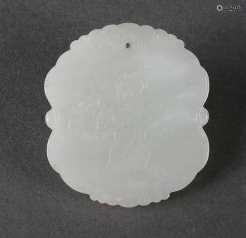 An inscribed white jade pendant