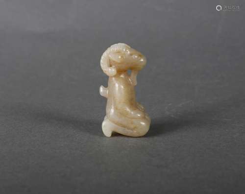 A white jade kneeling goat ornament