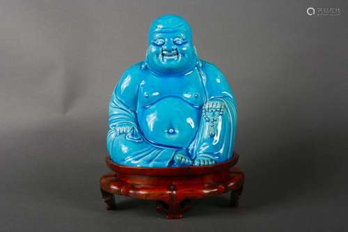 A peacock blue glazed porcelain Maitreya