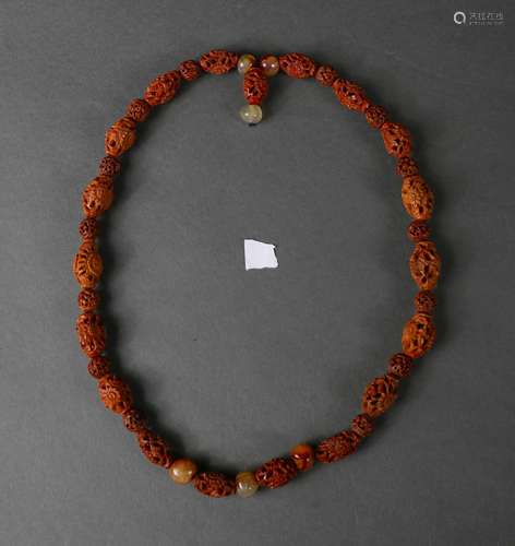 A fruit pit carved necklace