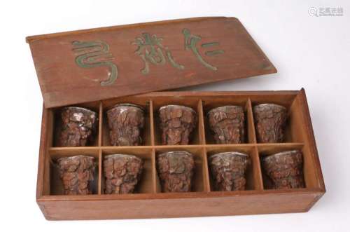 Cased set of ten Chinese carved wood and silver lined Libati...