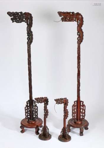 Set of four Chinese hardwood lamps, to include two standard ...