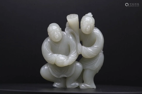 A PALE CELADON JADE CARVING OF TWO 'HEHE ERXIAN' F...