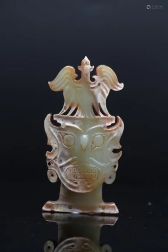 A YELLOW JADE CARVING OF A HUMAN FACE WITH BIRD MASK, QIJIA ...