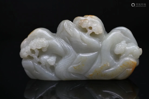 A CELADON JADE WITH RUSSET SKIN CARVING 'MOUNTAIN'...