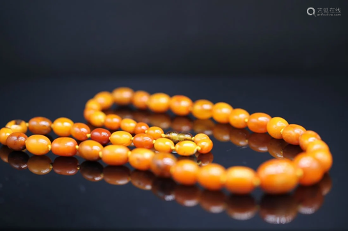 A CHINESE AMBER GRANDUATED BEAD NECKLACE, QING DYNASTY (priv...