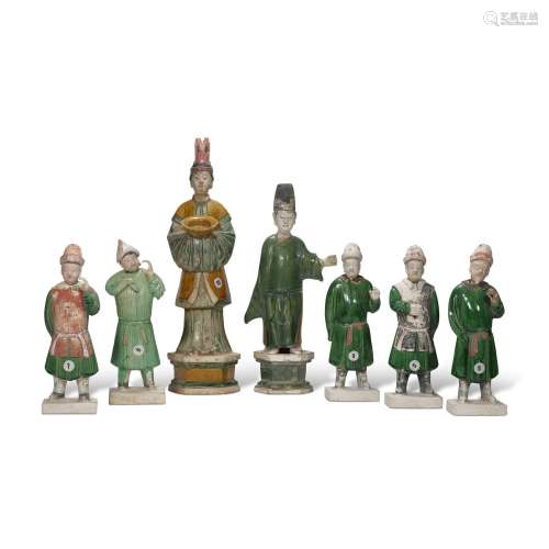 A GROUP OF SEVEN GREEN AND AMBER GLAZED POTTERY FIGURES