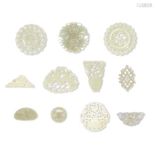 A GROUP OF ELEVEN WHITE AND PALE CELADON JADE OPENWORK ORNAM...