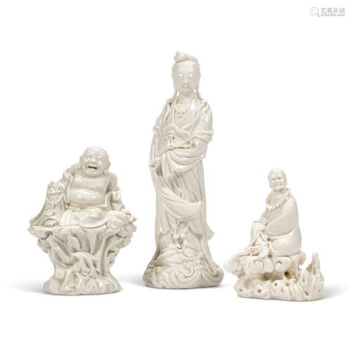 A GROUP OF THREE DEHUA FIGURES: A BUDHAI, A GUANYIN AND A LU...