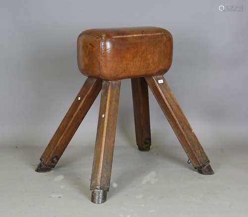 An early 20th century pommel horse with brown leather body a...