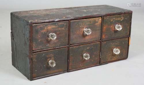 A 19th century primitive stained softwood bank of six drawer...