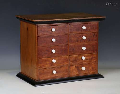 A 19th century satinwood and walnut table-top chest of ten d...