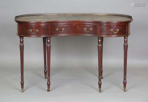 An early 20th century mahogany kidney shaped writing table, ...