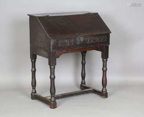 An early 18th century oak bible box, the sloping hinged lid ...