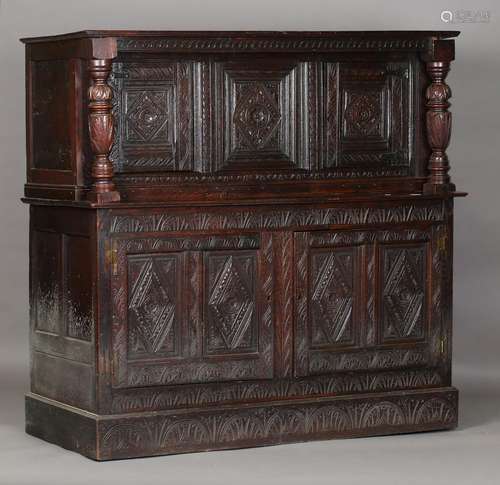 A 17th century oak court cupboard, fitted with profusely car...