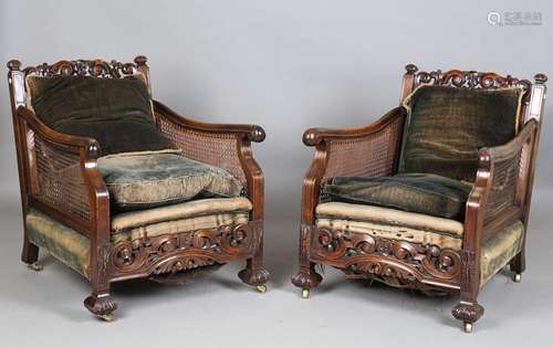 A pair of early 20th century walnut framed bergère armchairs...