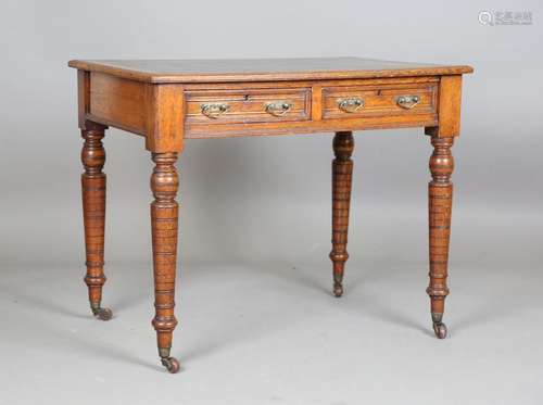 An Edwardian oak writing desk by S. & H. Jewell, the top...