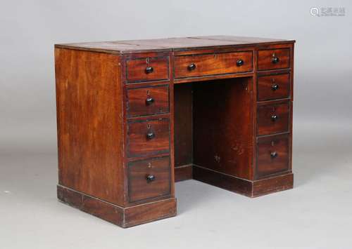 A George III mahogany twin pedestal writing desk, the hinged...