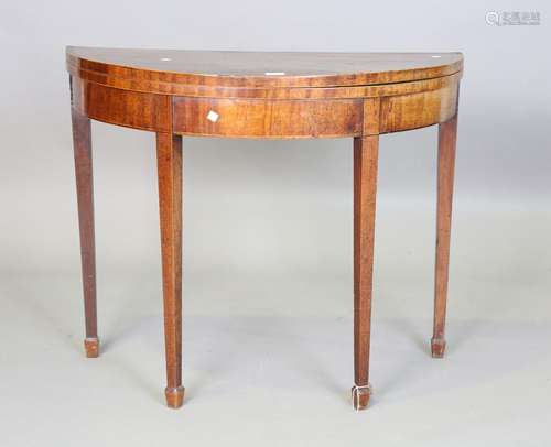 A George III mahogany demi-lune fold-over card table with cr...