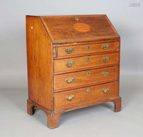 An Edwardian mahogany bureau with inlaid decoration, the fal...