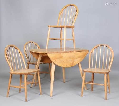 An Ercol elm fall-flap kitchen table and four spindle back W...