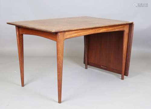 A mid-20th century teak drop-flap desk of retro design, rais...