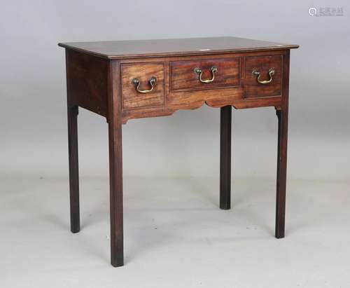 A George III mahogany side table, the moulded top above thre...