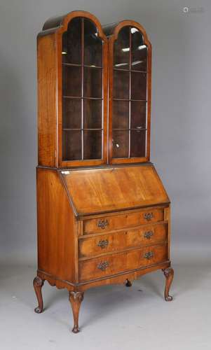 An early 20th century Queen Anne style walnut bureau bookcas...