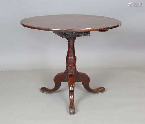 A George III mahogany circular tip-top supper table, on a tu...