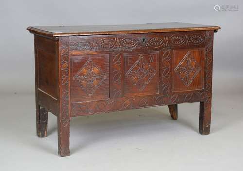 A late 17th century oak coffer, the triple panel front carve...