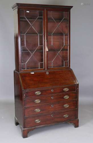 A George III mahogany bureau bookcase, the dentil pediment a...