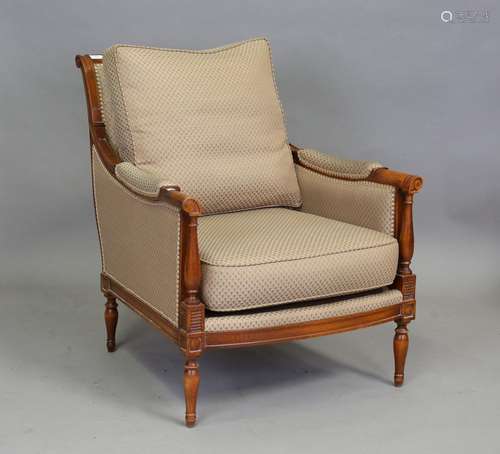 A 20th century George III style armchair, upholstered in pat...