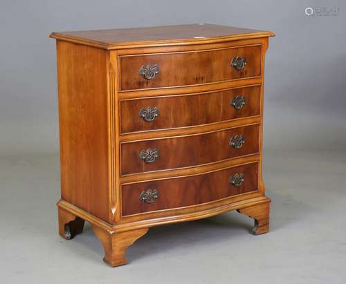 A modern yew serpentine fronted chest of four drawers, heigh...