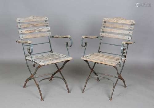 A pair of early 20th century wrought iron and wooden slatted...