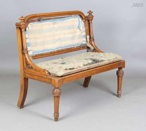 A Victorian oak hall bench with turned finials and fluted su...