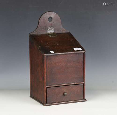 An early 19th century oak candlebox with hinged lid and sing...