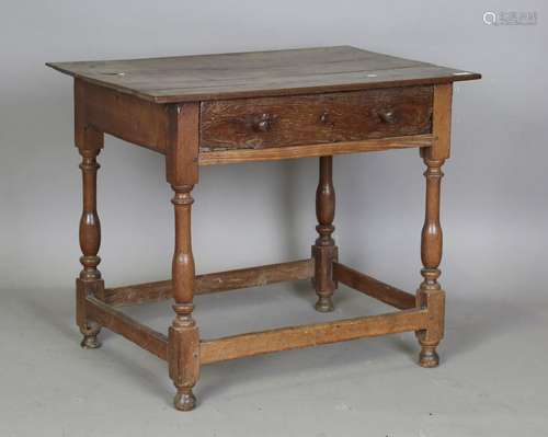 An 18th century oak side table, fitted with a drawer, raised...