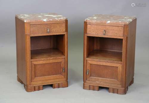 A pair of Art Deco French oak bedside cabinets with veined r...