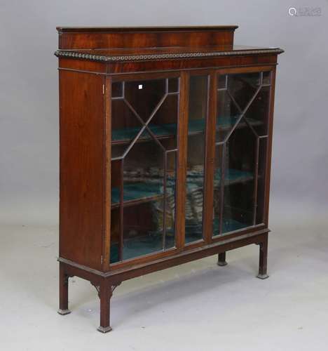 An early 20th century mahogany glazed bookcase with a gadroo...