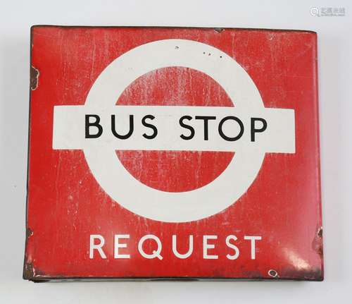 A double-sided enamel Bus Stop Request sign