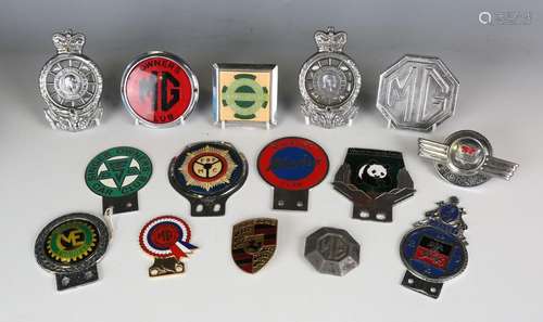 A collection of fifteen vintage car badges