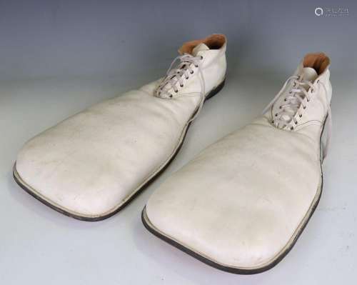 A pair of white leather clown's shoes