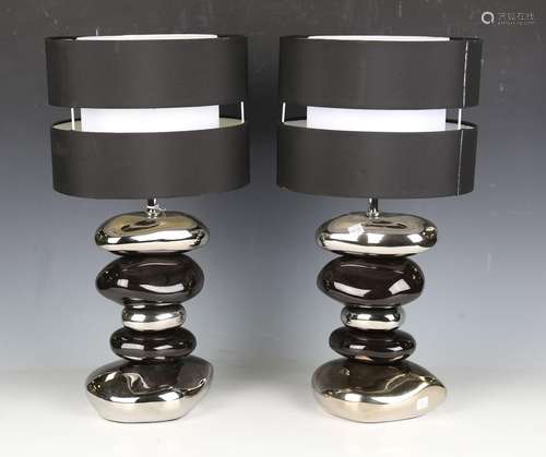 A pair of modern black and silver table lamps of stacked peb...