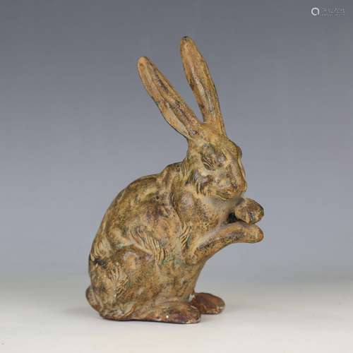 A 20th century patinated cast iron model of a seated hare