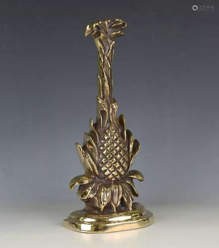 A cast brass half-block doorstop in the form of a pineapple ...